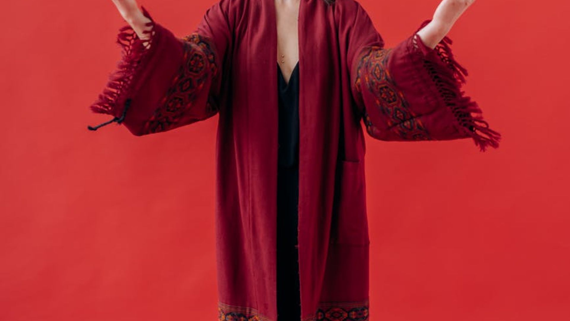A serene woman in a yoga pose against a calm, dark background.