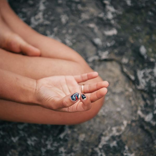Close-up of hands in a yoga mudra, showing focus.